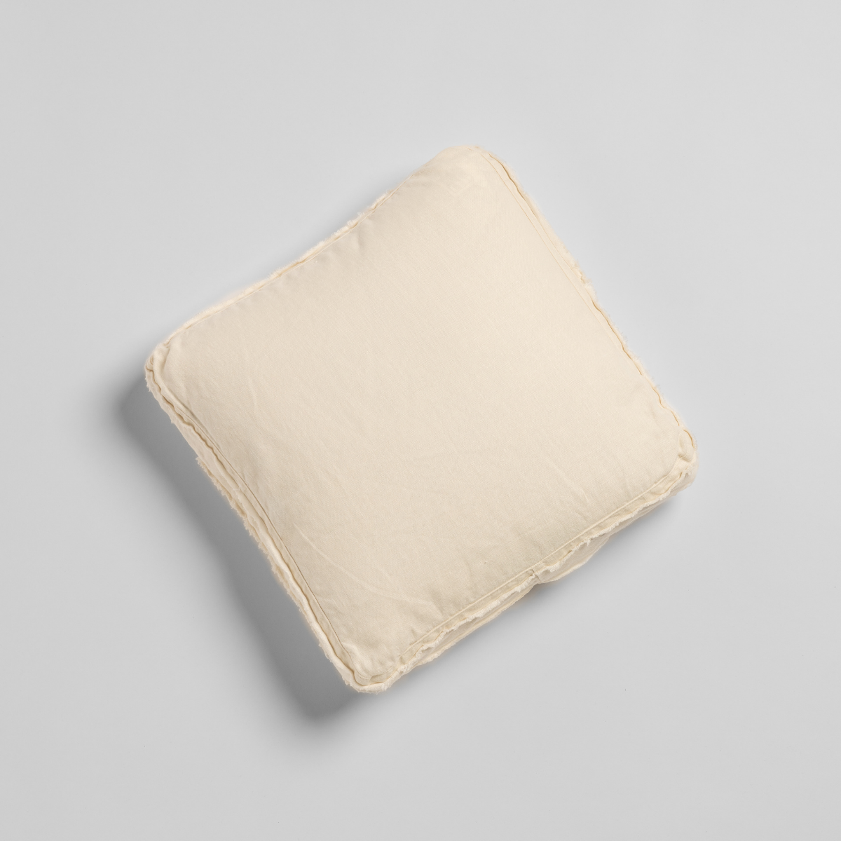 Austin Throw Pillow | Natural | An overhead shot of a midweight linen 18x18-inch throw pillow against a plain background.