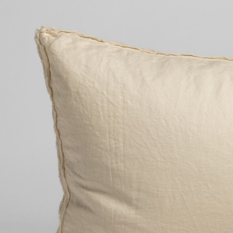 Austin Throw Pillow | Natural | a close up of the corner of a midweight linen sham.