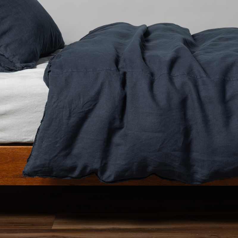 Austin Duvet Cover | Slate | midweight linen duvet cover with matching sham shown from the side on a bed against aa white background.