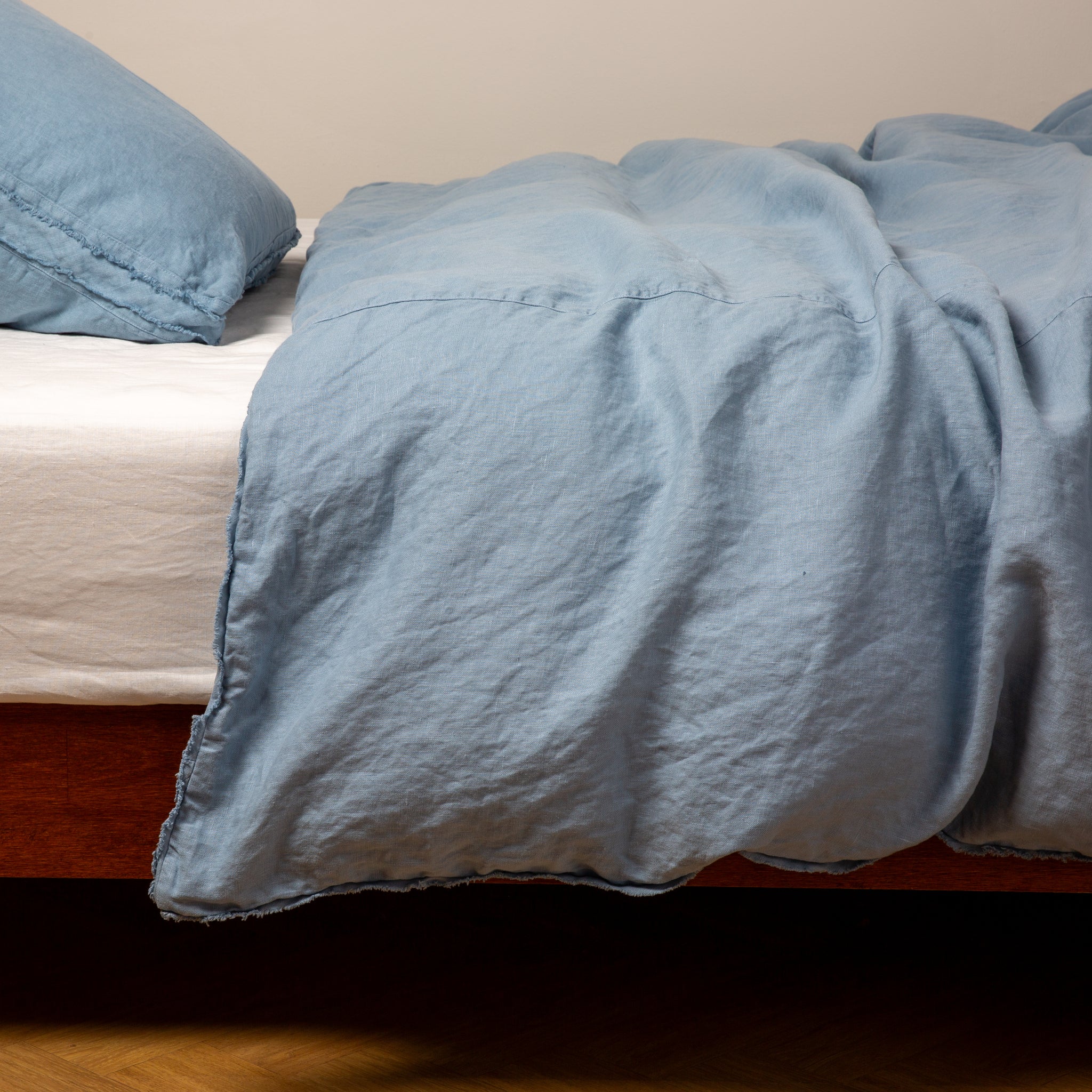 Austin Duvet Cover | Tahoe Blue | Midweight linen duvet cover in tahoe blue on a bed, side view.