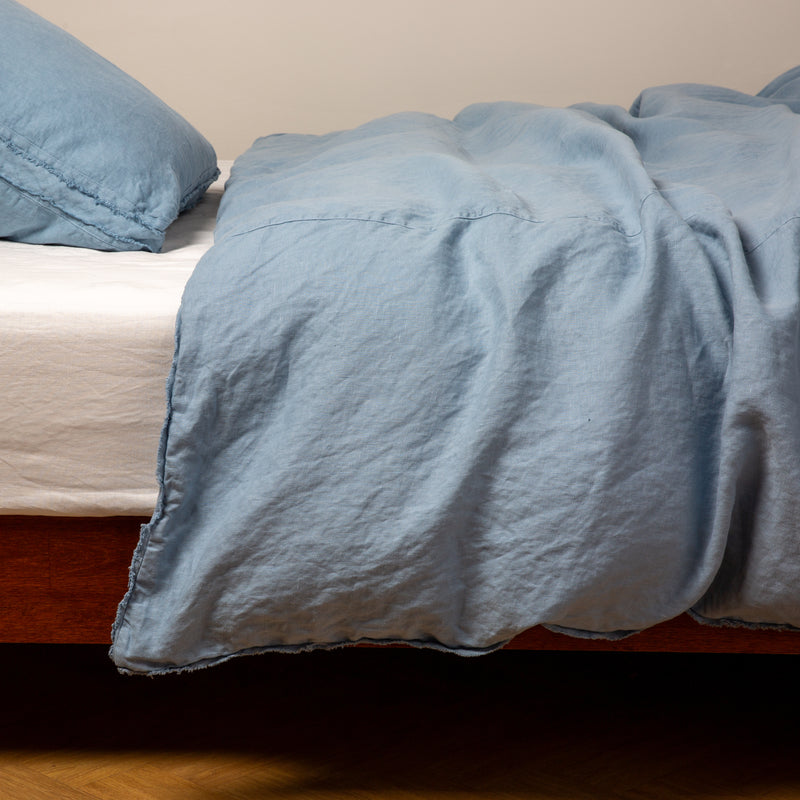 Austin Duvet Cover | Tahoe Blue | Midweight linen duvet cover in tahoe blue on a bed, side view.