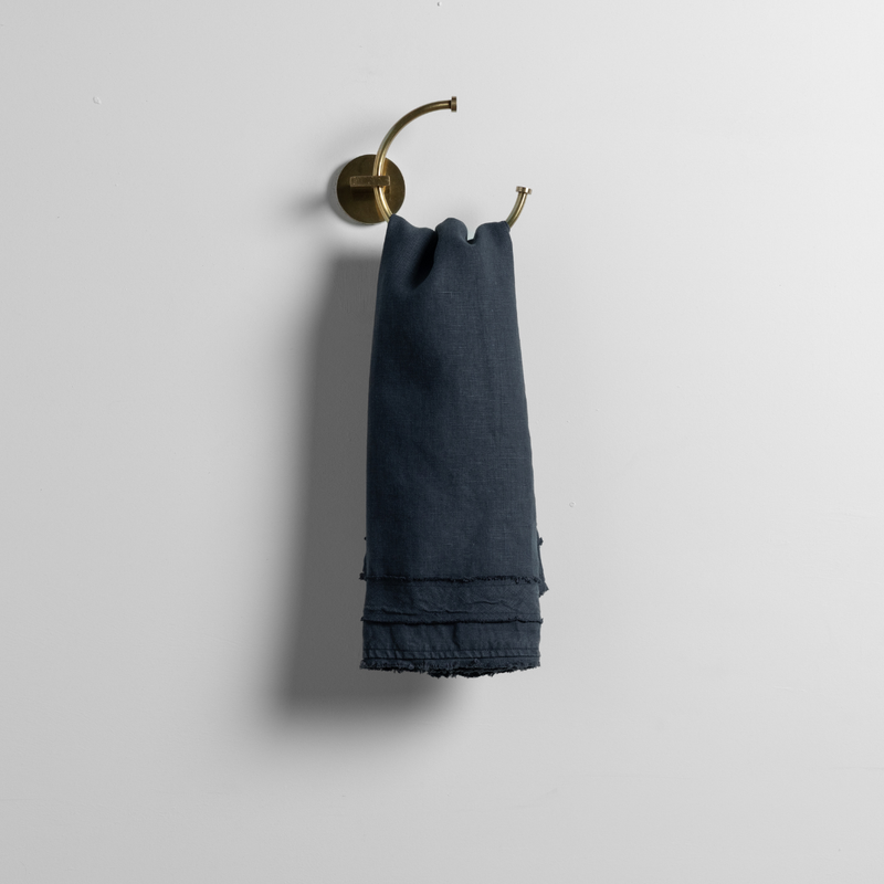 Austin Guest Towel | Slate | midweight linen guest towel on a decorative towel ring against a plain white background.