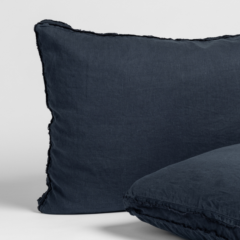 Slate | matching pair of austin shams in slate, a polished dusky dark blue, shown against a white background.