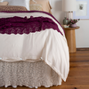 Allora Bed Skirt | cotton lace bed skirt and bed scarf shown from the foot of the bed dressed in light tones with pops of color.