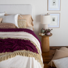Allora Bed Scarf | rumpled lace bed scarf layered ontop of a silk velvet throw blanket at the foot of a bed dressed in light tones with pops of color.