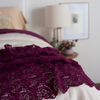 Allora Bed Scarf | a close up of the lace bed scarf rumpled at the foot of a bed, the rest of the shot is out of focus.