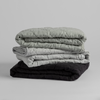Austin Blanket - Holiday Release | stack of three quilted midweight linen blankets against a plain white background.