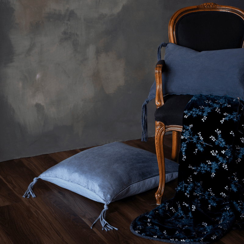 Lynette Blanket | Midnight | a throw pillow on a classic armchair with matching pillows from the taline collection.