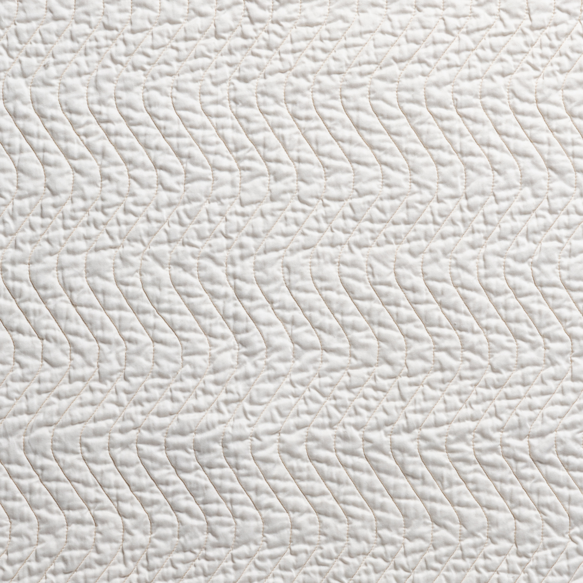Cirillo Blanket | Natural | a closeup of cirillo quilted cotton sateen in natural, a warm neutral.
