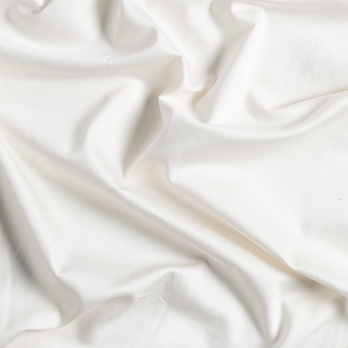 Bria Twin Fitted Sheets | Natural | a close up of gently swirled cotton sateen in natural, a warm neutral.