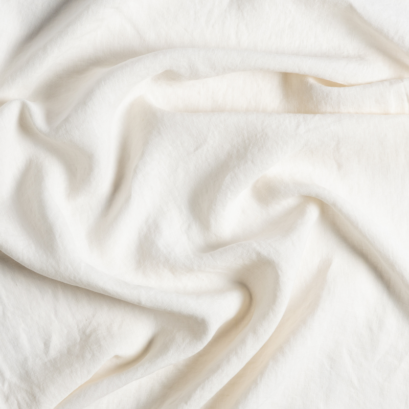 Linen Twin Bed Skirt | Natural | a close up of gently swirled signataure linen in natural, a warm neutral.