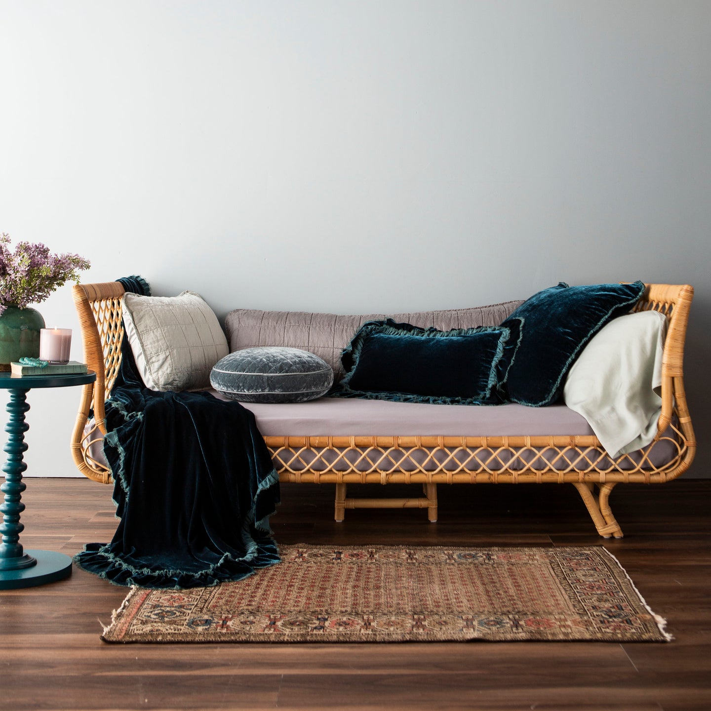 Block Schedule: Madera Luxe dressed daybed in shades of French Lavender, Eucalyptus, and Mineral. Atop the bed are a Loulah Throw Pillow and Blanket in our dark Cenote color way.