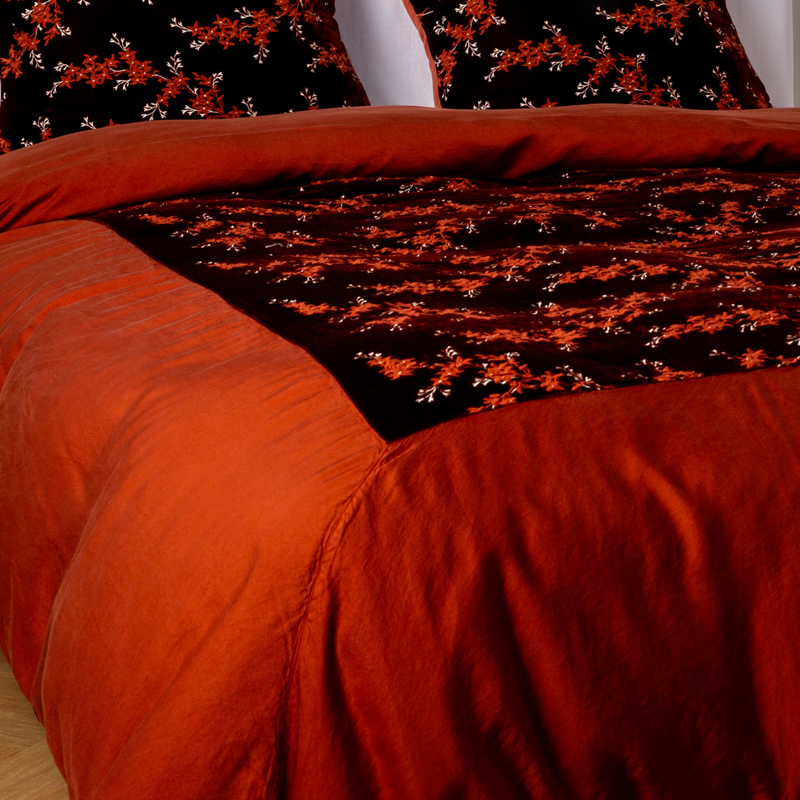 Lynette Luxe Duvet Cover | Autumn | A close-up of the mitered corner of an embroidered silk velvet and tencel duvet cover — its matching shams barely visible in the shot.