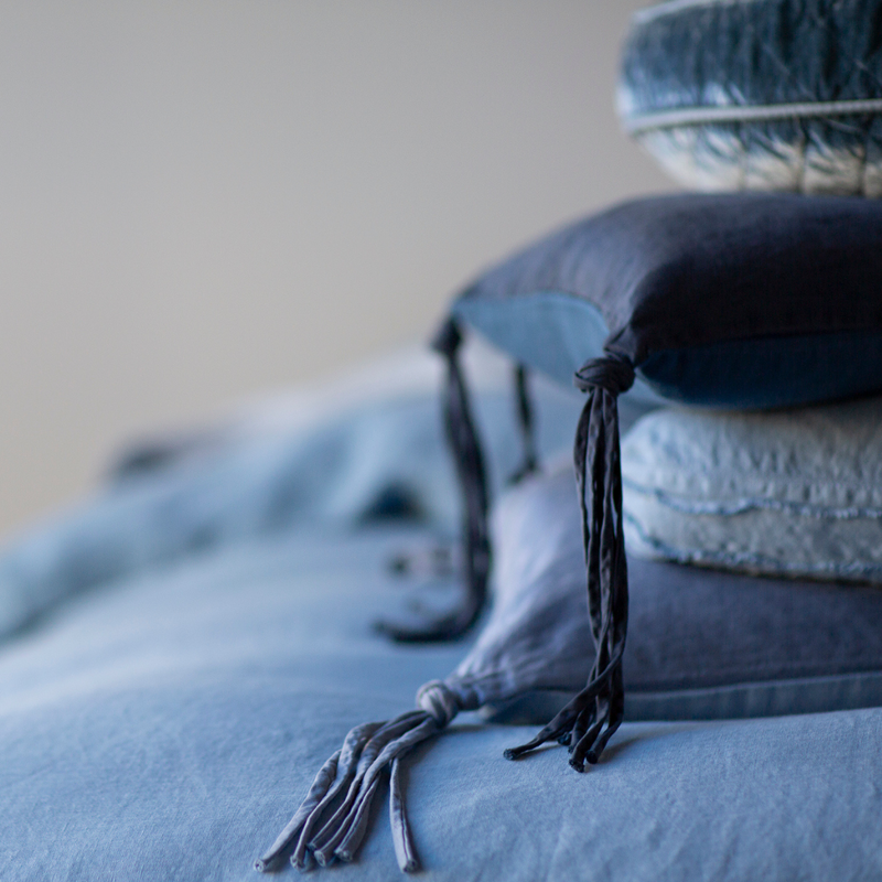 Taline Sham | An upclose shot of throw plllows with a focus on the ties of the Taline throw pillows in tahoe blue 