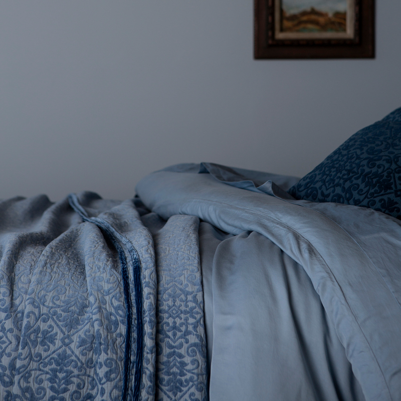 Vienna Coverlet | Tahoe Blue | a coverlet layered over a duvet cover and flat sheet with matching pillows.