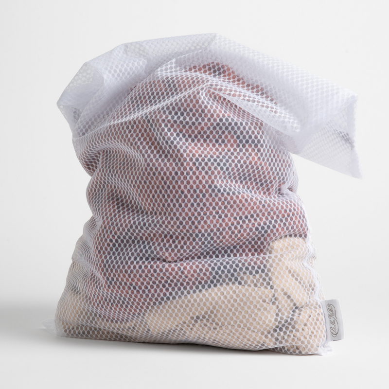 Mesh laundry bag shown stuffed with fabrics standing upright against a white background.