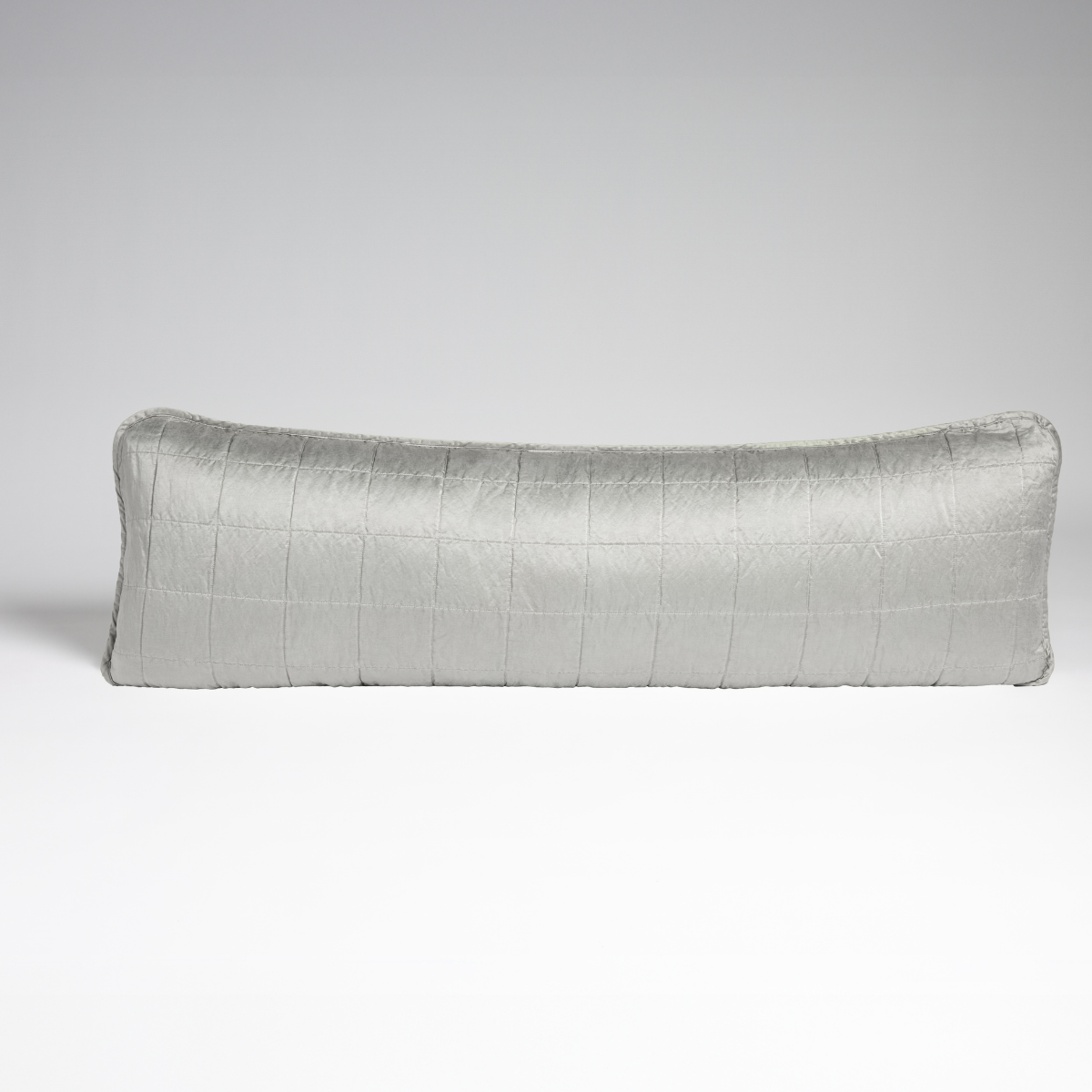 Sel Throw Pillow | Cloud | A straight-on shot of a square-quilted body pillow in cloud, a subtle sky blue-grey, against a white background.