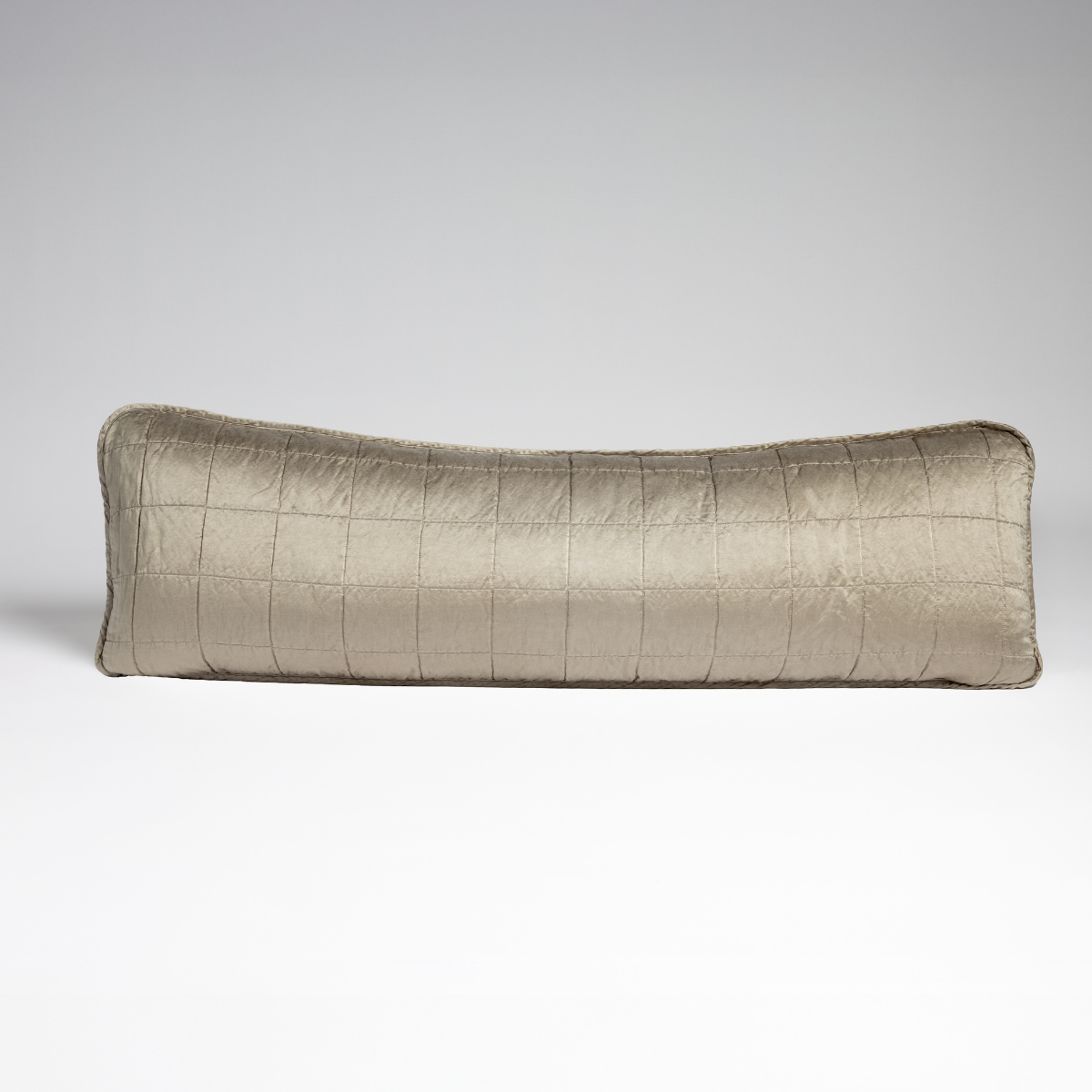 Sel Throw Pillow | Moonlight | A straight-on shot of a square-quilted body pillow in moonlight, a saturated, cool, mid-dark grey tone, against a white background.