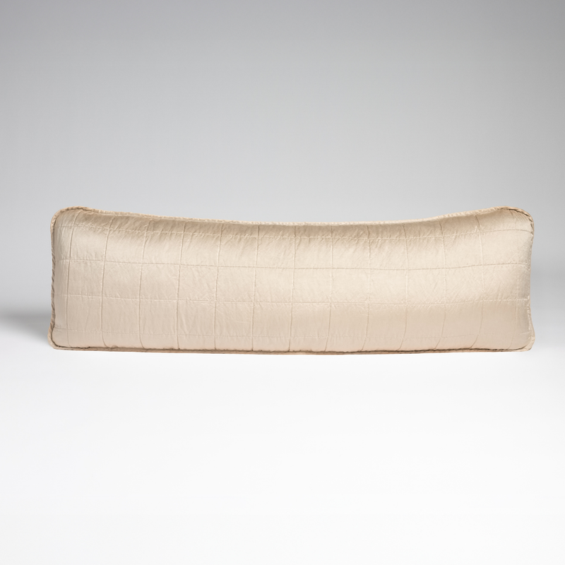 Sel Throw Pillow | Pearl | A straight-on shot of a square-quilted body pillow in pearl, a soft rose pink tone, against a white background.