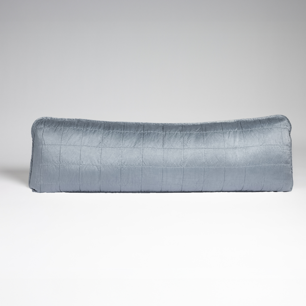 Sel Throw Pillow | Tahoe Blue | A straight-on shot of a square-quilted body pillow in tahoe blue, a crisp true blue, against a white background.