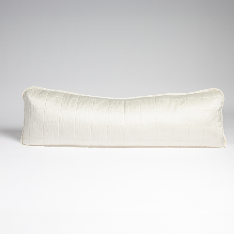 Sel Throw Pillow | Winter White | A straight-on shot of a square-quilted body pillow in winter white, a softer and warmer tone than our classic white, against a white background.