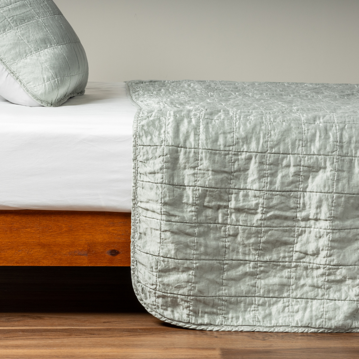 Sel Coverlet | Mineral | A side shot of a square quilted charmeuse coverlet in mineral, a soothing seafoam blue with subtle grey-green undertones, with its matching sham.