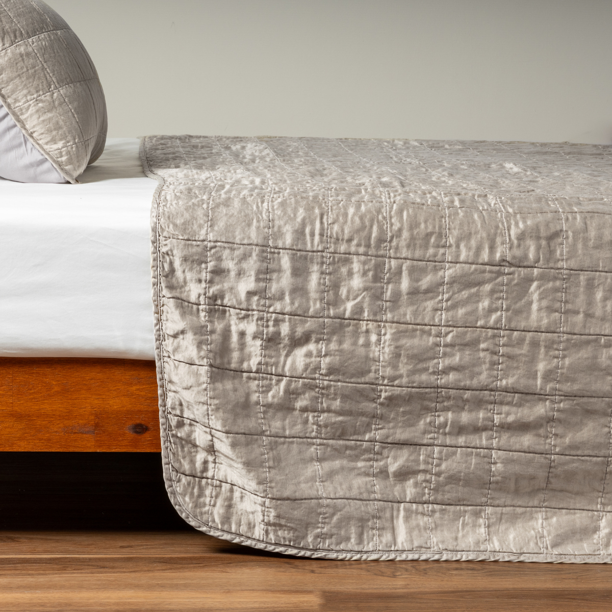 Sel Coverlet | Moonlight | A side shot of a square quilted charmeuse coverlet in moonlight, a saturated, cool, mid-dark grey tone, with its matching sham.