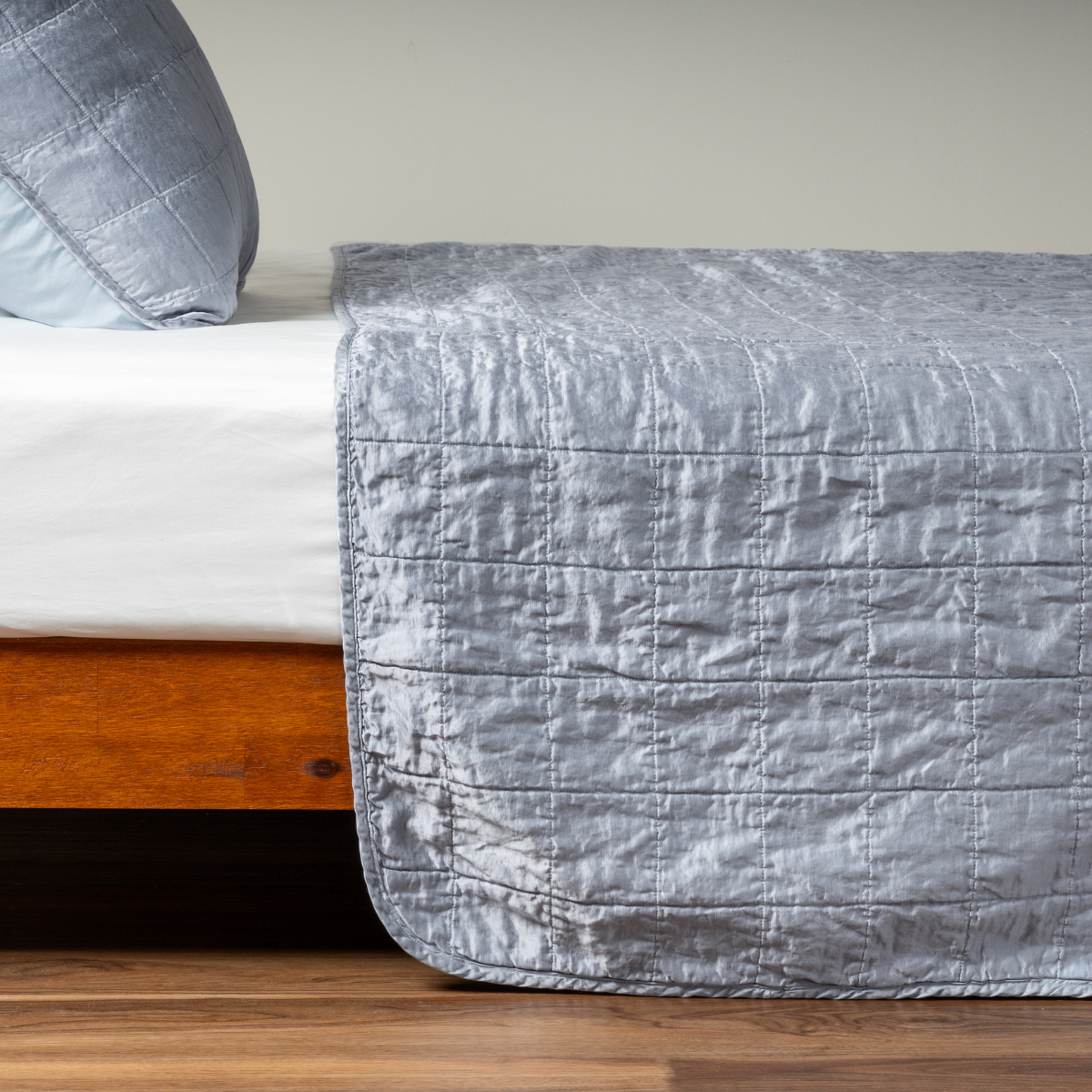 Sel Coverlet | Tahoe Blue | A side shot of a square quilted charmeuse coverlet in tahoe blue, a crisp true blue, with its matching sham.