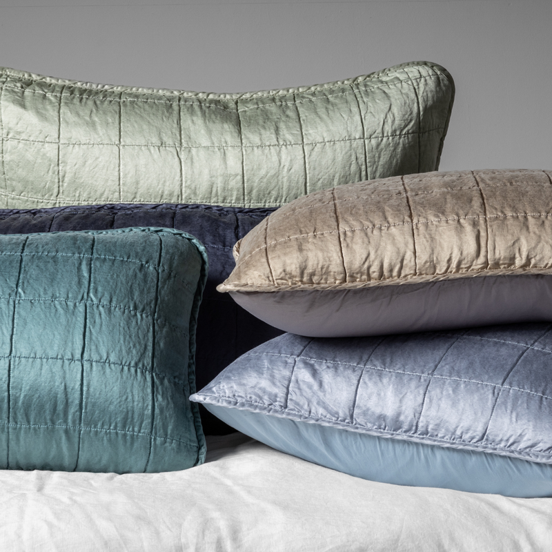 Sel Sham | A cluster shot of five square-quilted charmeuse shams showing their unquilted cotton sateen back. 