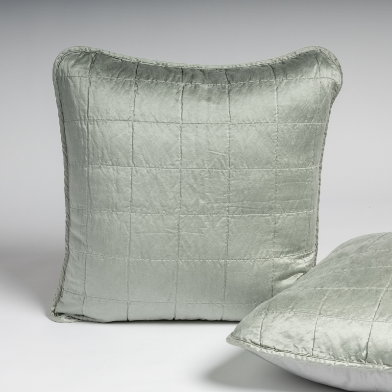 Sel Sham | Mineral | A pair of shams shown in mineral, a soothing seafoam blue with subtle grey-green undertone, against a white background with one sham upright and the other on its side to show the cotton sateen back and square-quilted charmeuse front.