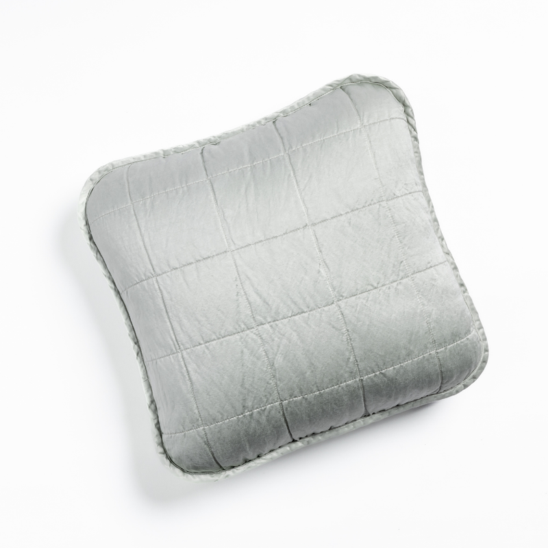 Sel Throw Pillow | Cloud | An overhead shot of a square-quilted square throw pillow in cloud, a subtle sky blue-grey, against a white background.
