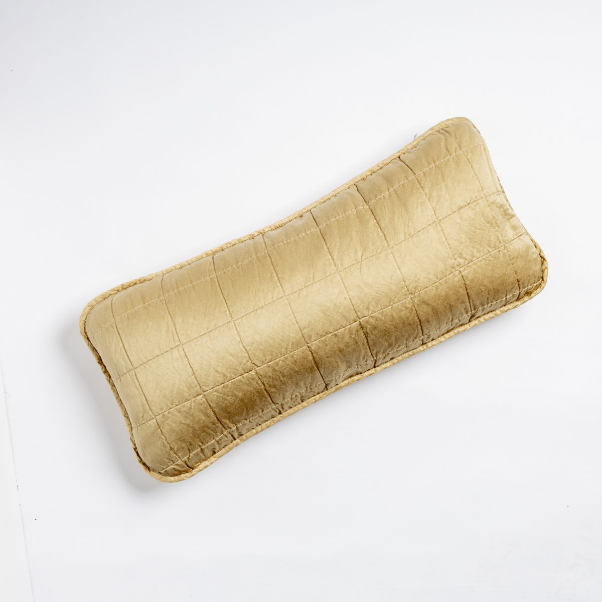 Sel Throw Pillow | Honeycomb | An overhead shot of a square-quilted rectangle throw pillow in honeycomb, a warm golden tone, against a white background.