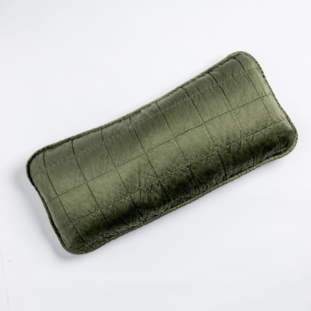 Sel Throw Pillow | Juniper | An overhead shot of a square-quilted rectangle throw pillow in juniper, a deeply saturated dark green, against a white background.