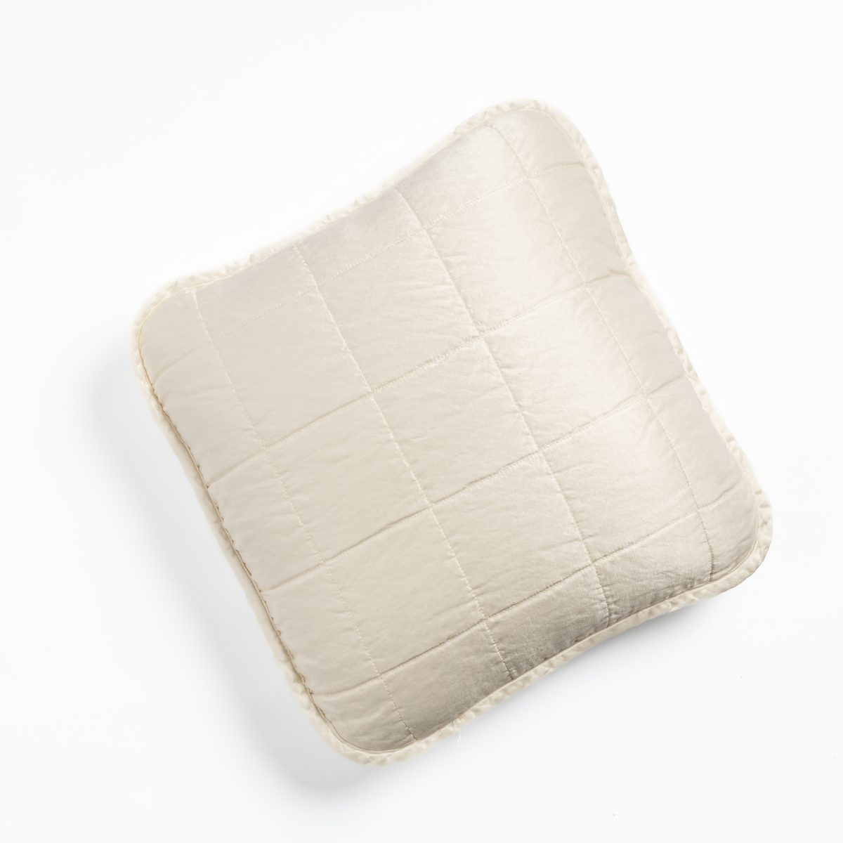 Sel Throw Pillow | Winter White | An overhead shot of a square-quilted square throw pillow in winter white, a softer and warmer tone than our classic white, against a white background.