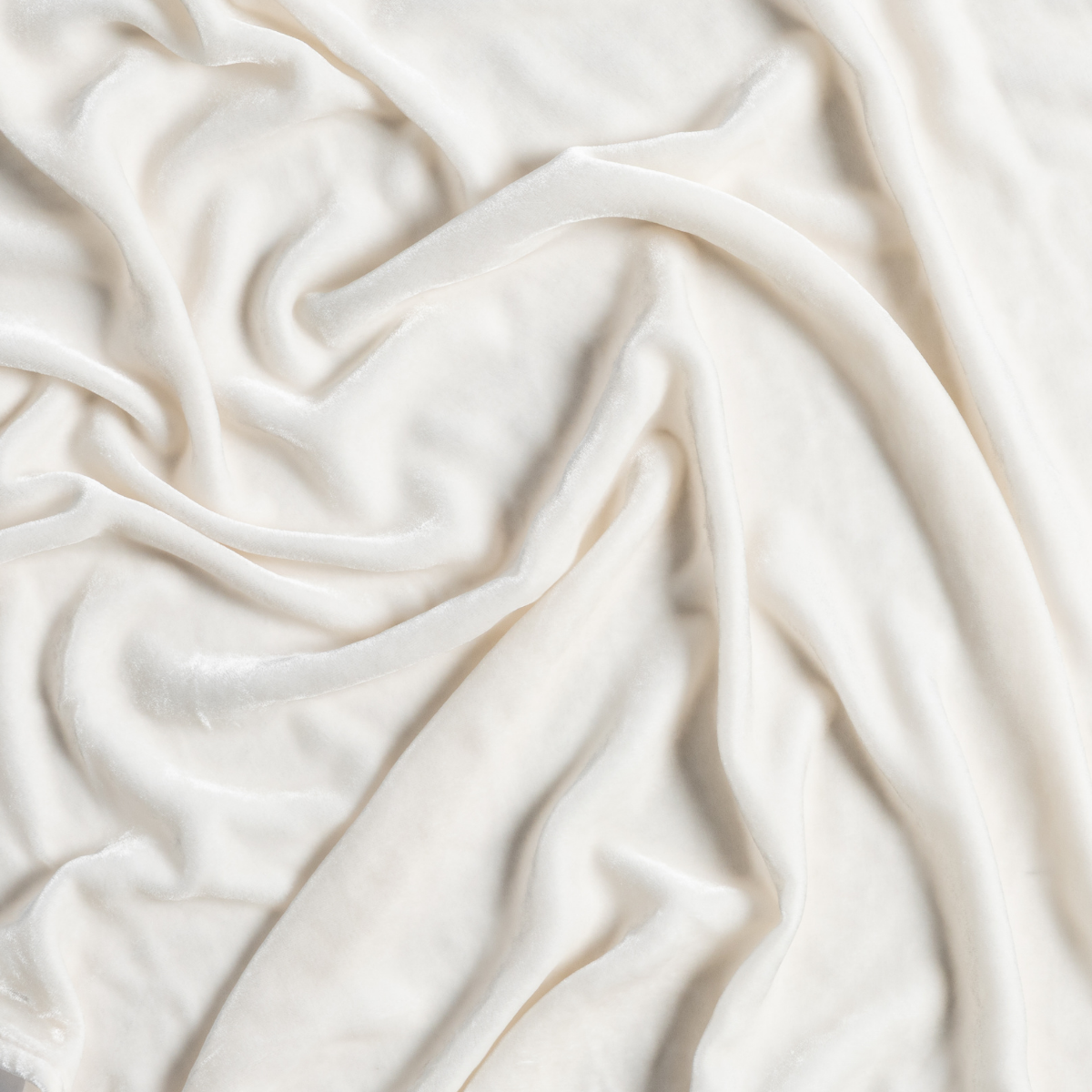 Carmen Blanket | Crema | a closeup of gently rumpled silk velvet in crema, a silky and warm neutral