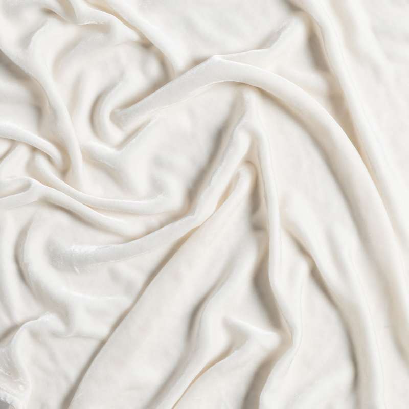 Carmen Blanket | Crema | a closeup of gently rumpled silk velvet in crema, a silky and warm neutral