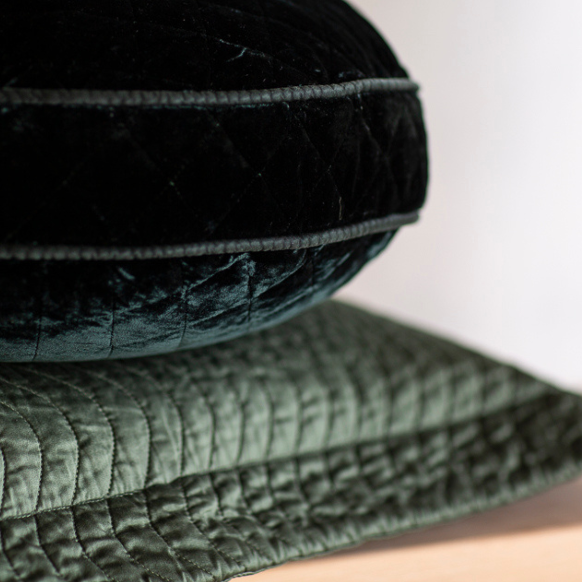 Silk Velvet Quilted Throw Pillow | Juniper | a quilted silk velvet round pillow stacked on a quilted cotton sateen throw pillow - both in Juniper.