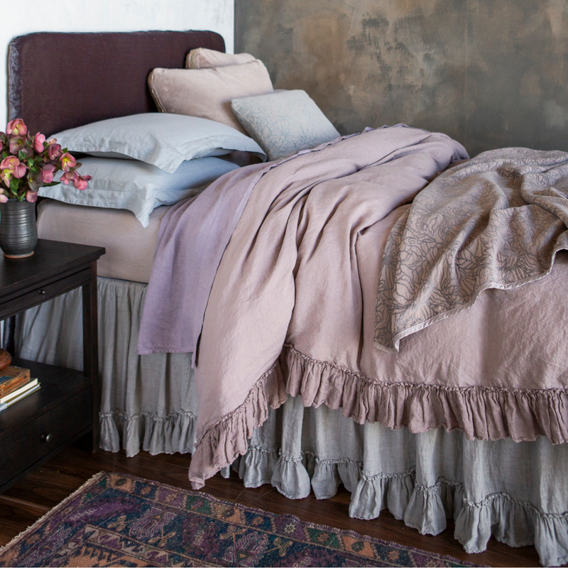 Georgia Blanket | a fully dressed bed in linen with cotton velvet and chenille and cotton jacquard shams and accent pieces.