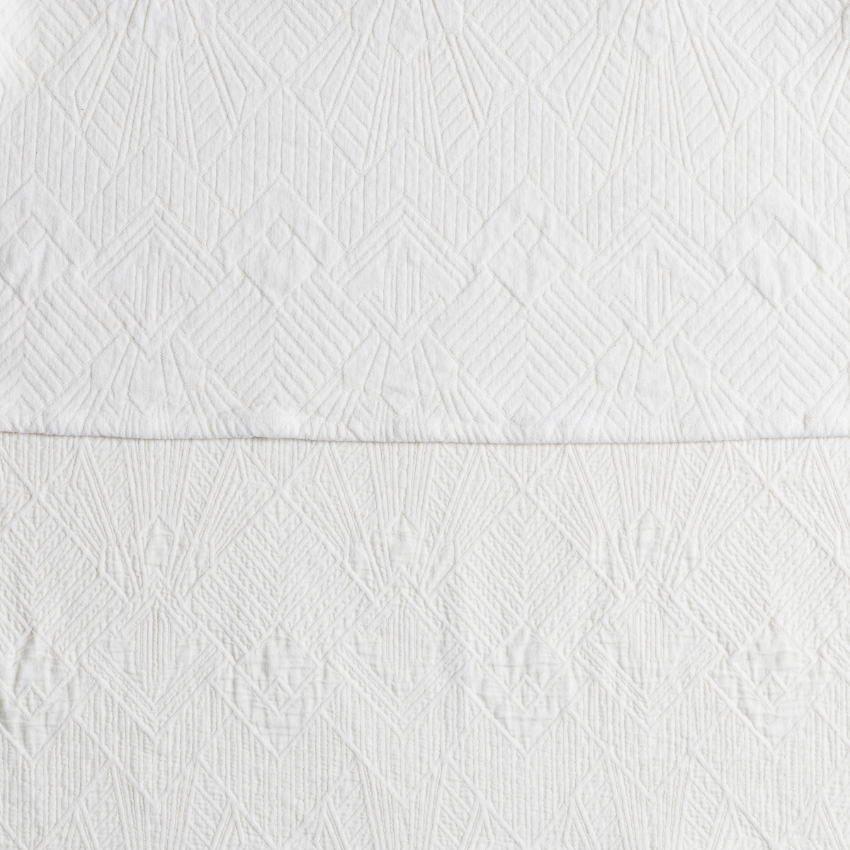 The Trettino Collection | Winter White | a close-up showing the chenille jacquard on the top half and cotton jacquard on the bottom in winter white, a wooly white.