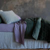 Harlow Sham | sham shown with neatly turned down bed in green and purple tones shown from the side.