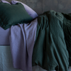 Linen Sham | Juniper | a standard sham shown with linen sheets, midweight linen duvet cover and a glimpse of quilted cotton velvet - shown in green and purple tones.