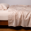 Bria Twin Fitted Sheets | Pearl | Cotton sateen fitted sheet shown with matching flat sheet and sleeping pillow - side view.