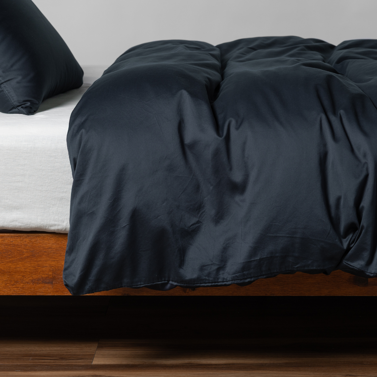 Bria Duvet Cover | Slate | cotton sateen duvet cover with matching pillowcase shown from the side on a bed against aa white background.