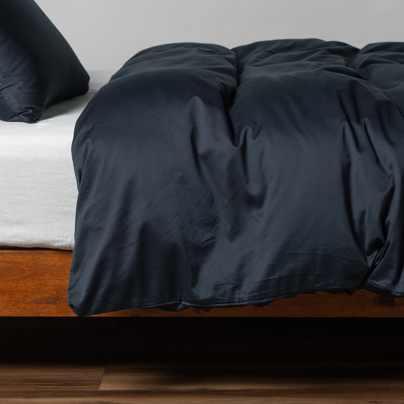 Bria Duvet Cover | Slate | cotton sateen duvet cover with matching pillowcase shown from the side on a bed against aa white background.