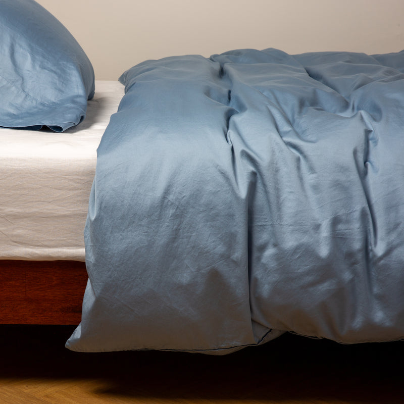 Bria Twin Duvet Cover | Tahoe Blue | duvet cover and matching sleeping pillow on white sheeting - side view.
