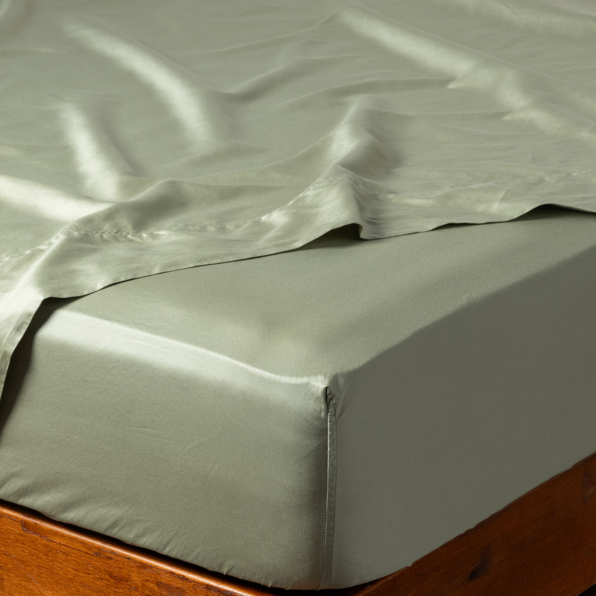 Bria Twin Fitted Sheets | Desert Sage | a fitted sheet corner in desert sage, a serenely elegant green, offering a hushed hue, shown with a matching flat sheet.