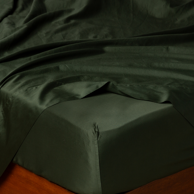 Bria Twin Fitted Sheets | Juniper | Cotton sateen fitted sheet shown from the top corner, highlighting the shine of the fabric.