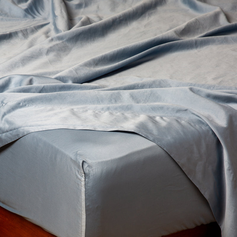 Bria Fitted Sheet | Tahoe Blue | Cotton sateen fitted sheet shown from the top corner, highlighting the shine of the fabric.