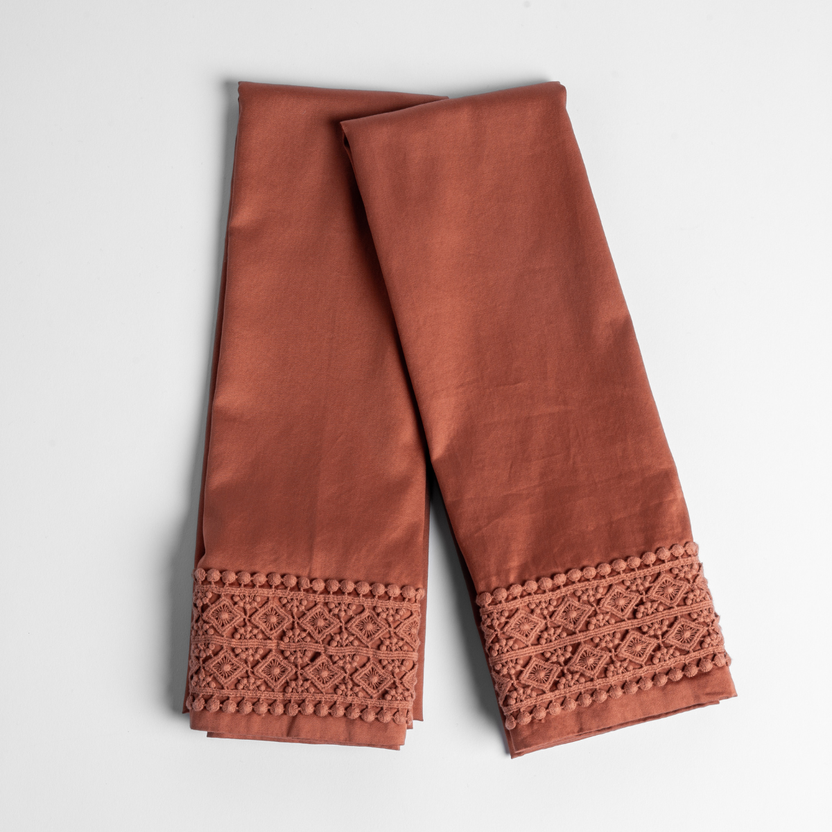 Bria Pillowcase (Single) | Autumn | A pair of folded Bria Novola pillowcases without inserts in Autumn, a rich terracotta tone, shown against a white background.