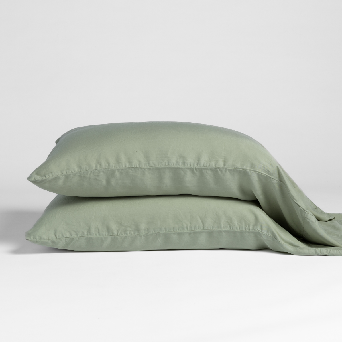 Bria Standard Pillowcase (Single) | Desert Sage | matching pillowcases in desert sage, a serenely elegant green, offering a hushed hue, shown against a plain background.